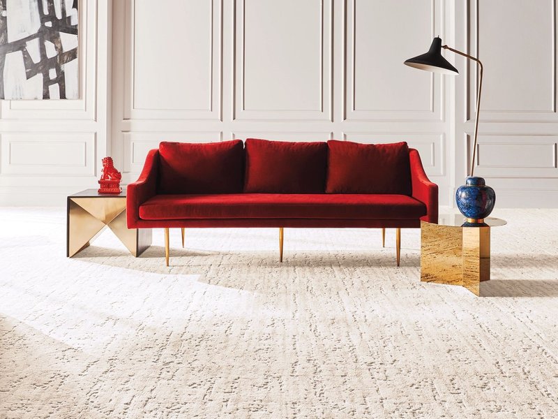Bright living room with a red velvet couch and beige textured carpet from Floor Fashions of Virginia in the Charlottesville, VA area