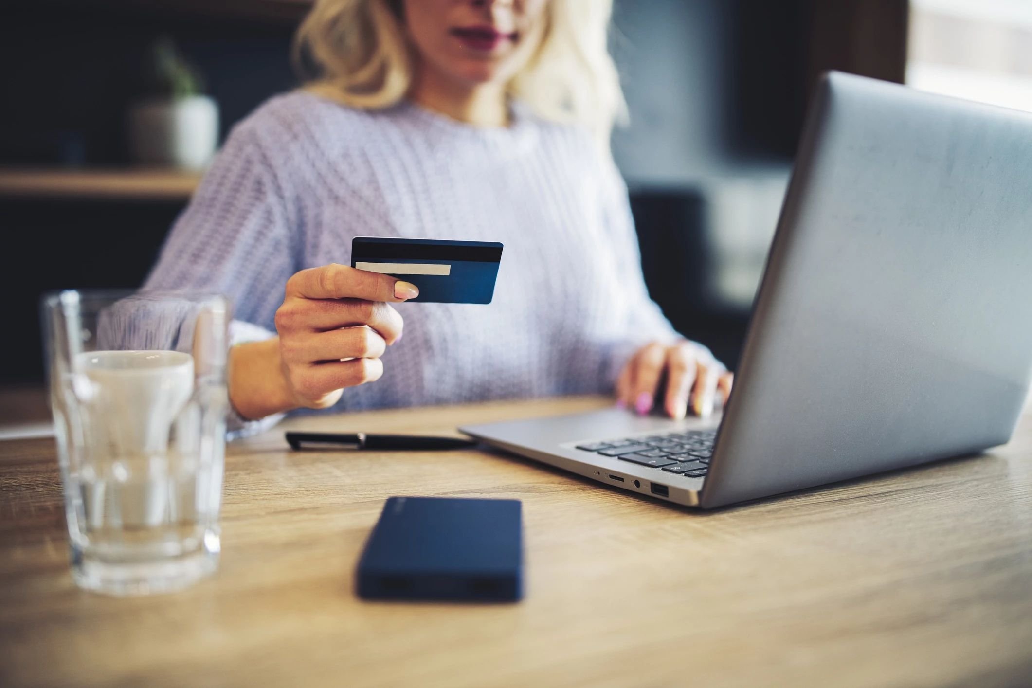 person using laptop to pay online with credit card - Floor Fashions of Virginia in the Charlottesville, VA area