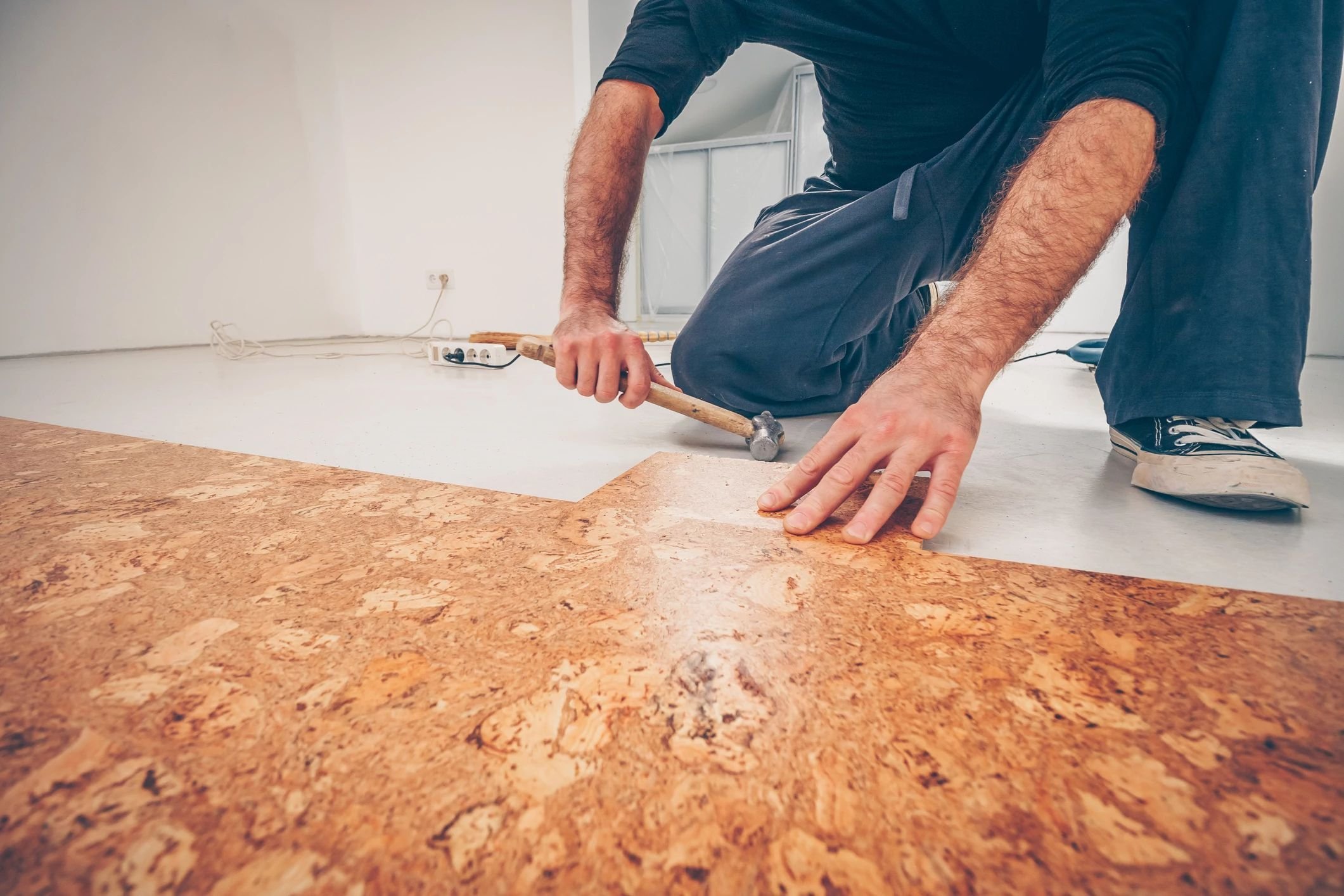 person installing cork flooring from Floor Fashions of Virginia in the Charlottesville, VA area