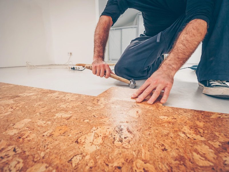 person installing cork flooring from Floor Fashions of Virginia in the Charlottesville, VA area